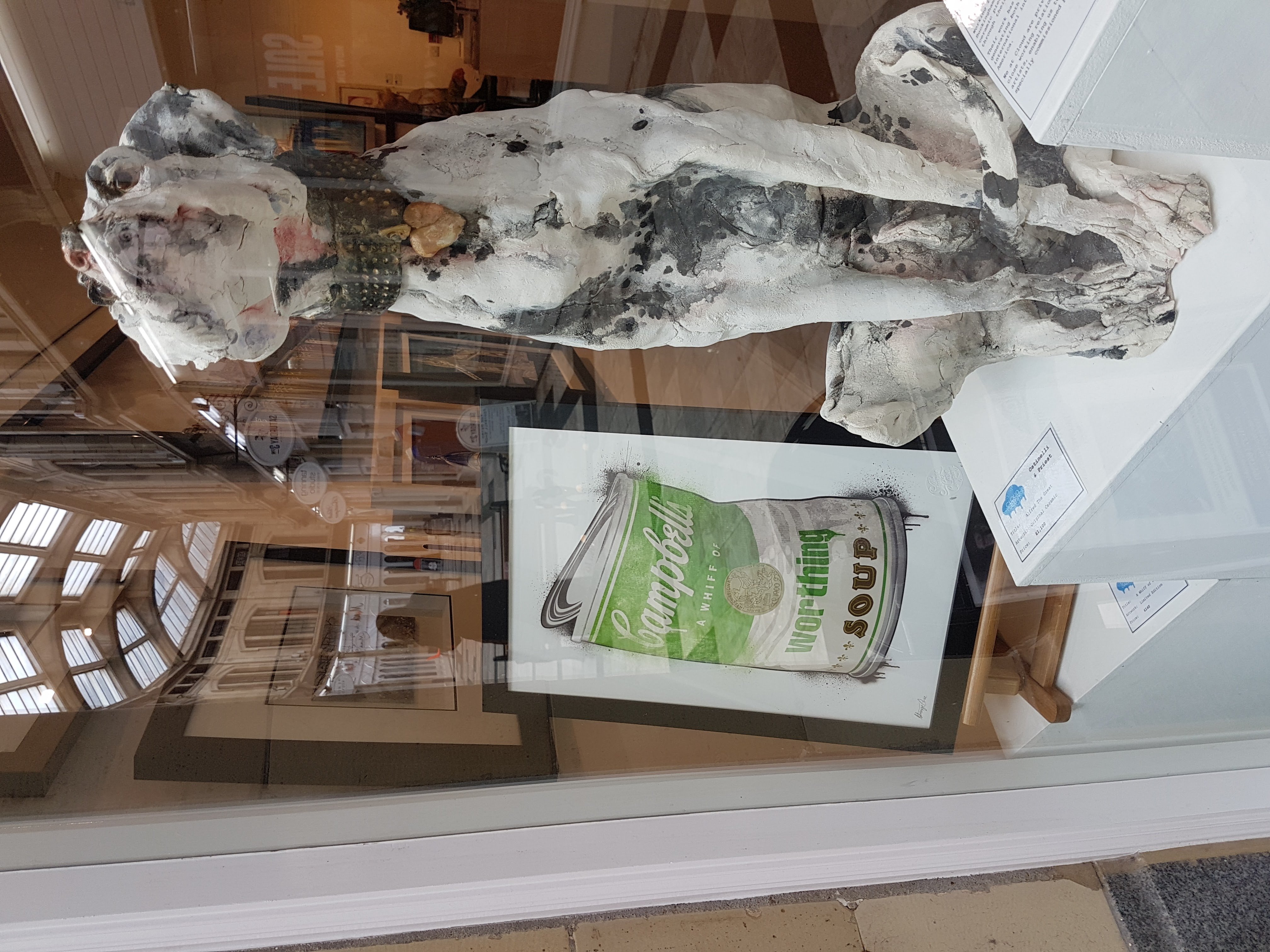 Whiff of Worthing soup print in the window beside a ceramic hound
