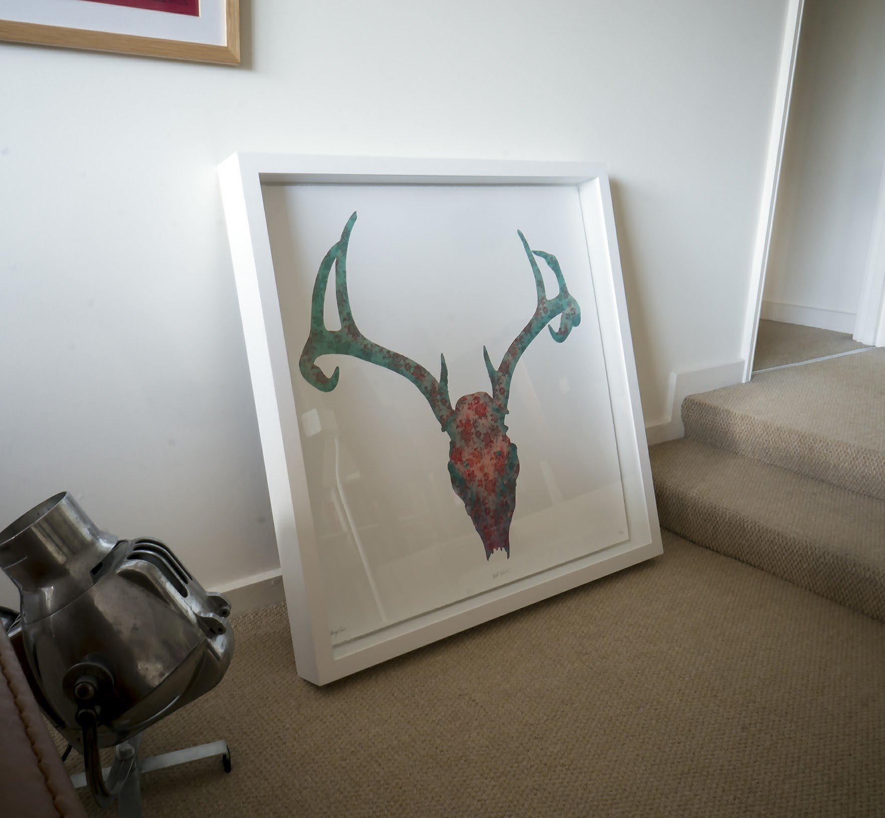 Floral stag skull print in a white box frame, fresh from the framers